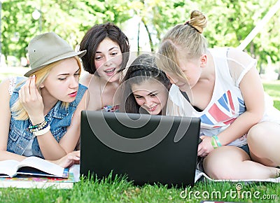 Group of young student using laptop together