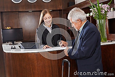 Guest signing form at hotel reception