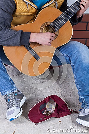 Guitar player collecting money