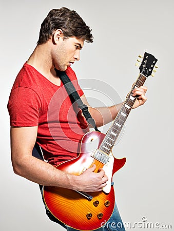 Guitarist plays on the electric guitar