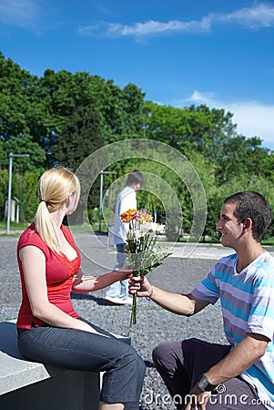 http://thumbs.dreamstime.com/x/guy-gives-to-girl-flowers-12068507.jpg
