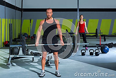 Gym with weight lifting bar workout man and woman