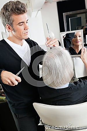 Hairstylist Cutting Hair At Salon