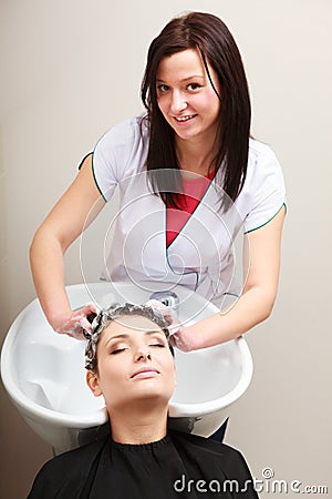 Hairstylist washing woman hair. Hairdressing beauty salon