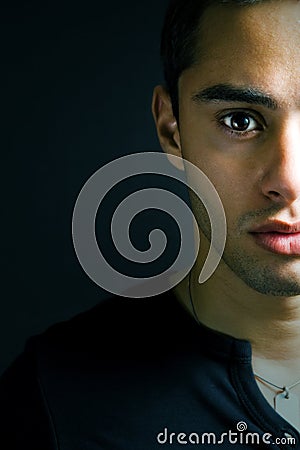 Half face portrait of one serious young man