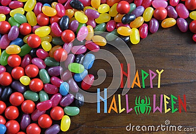 Halloween candy on rustic dark wood background with sample text