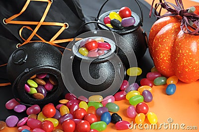 Halloween candy in trick or treat carry cauldrons closeup.