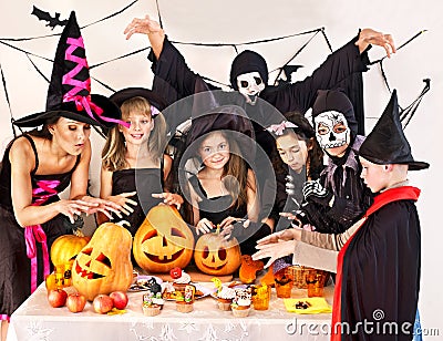 Halloween party with children holding trick or treat.