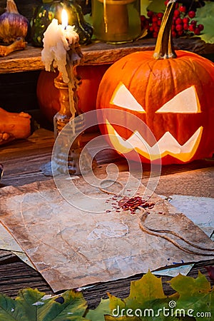 Halloween pumpkin and candle on witch s table