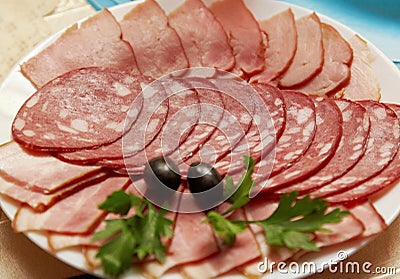 Ham and sausage served on plate