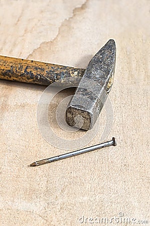 Hammer and nail on wooden board