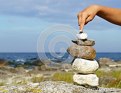 Hand balancing pile of stones