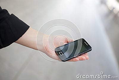 Hand of a businessman holding a mobile.