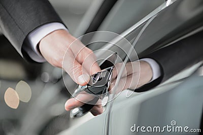 Hand on the car handle. Businessman holding his hand on the casr