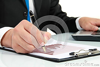 Hand checking at diagram on financial report