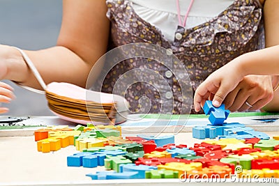 Hand child playing with construction blocks