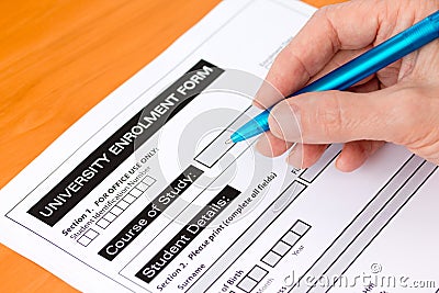 Hand Completing a University Application Form