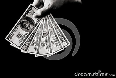 Hand with dollars over black