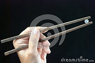 Holding Gem Using Chopsticks Holding Gem Using Chopsticks Royalty Free Stock Photo