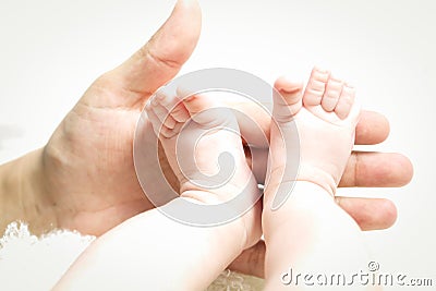 Hand holding little feet