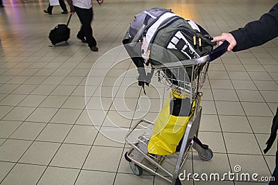 Hand luggage on cart in airport