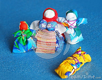 Hand-made colorful dolls on blue background