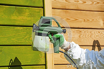 Hand painting wall with spray gun