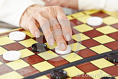 Hand of a senior woman playing