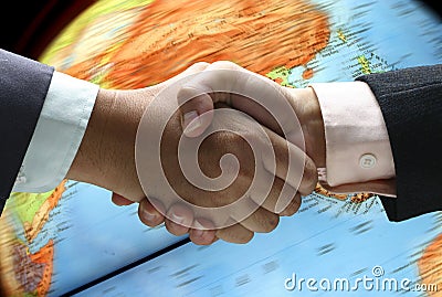 Hand shake over globe