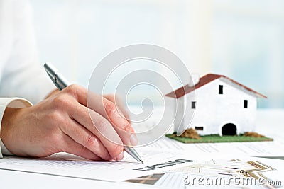 Hand signing real estate contract.