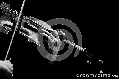 Hand of a woman playing violin on black background