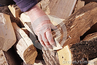 Hand of worker on a stack of wood