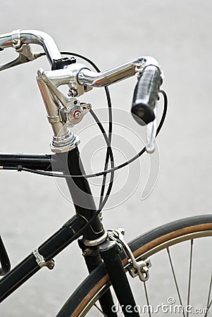 Handle bar of a black bicycle with black grip