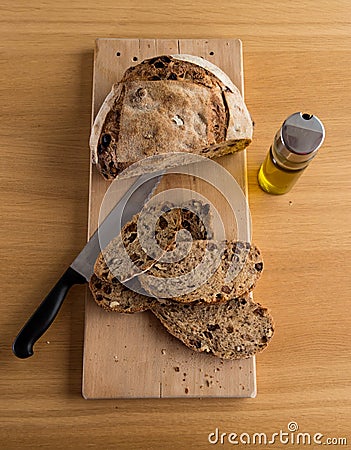 Handmade bread just cut closed to an oil bottle