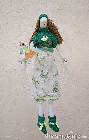 Handmade doll with a bird on the hand in a dress a