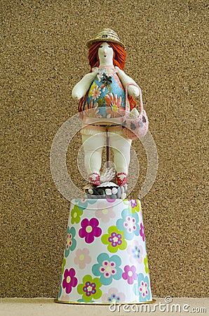Handmade doll plump woman in a bathing suit and a straw hat on a