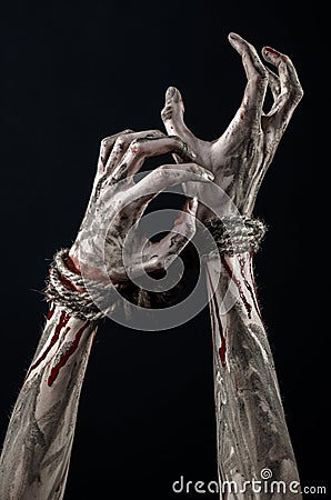 Hands bound,bloody hands, mud, rope, on a black background, isolated, kidnapping, zombie, demon