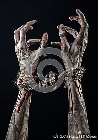 Hands bound,bloody hands, mud, rope, on a black background, isolated, kidnapping, zombie, demon