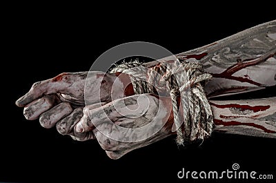 Hands bound,bloody hands, mud, rope, on a black background, isolated, kidnapping, zombie, demon