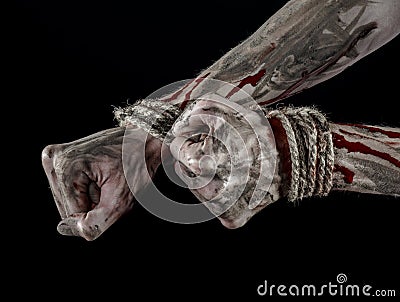 Hands bound,bloody hands, mud, rope, on a black background, isolated, kidnapping, zombie, demon