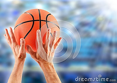 Hands catching basketball