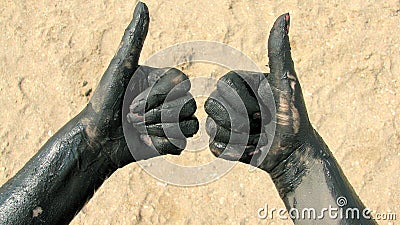 Hands covered with therapeutic mud