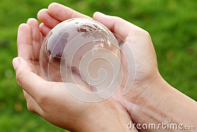 Hands holding a glass globe