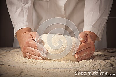 Hands kneading bread dough