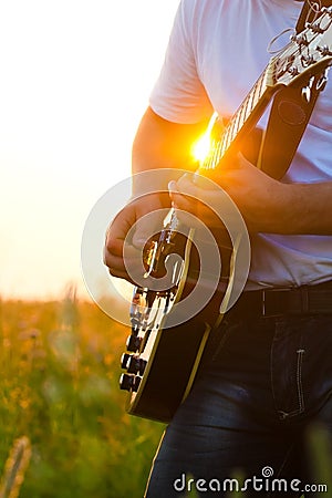 Hands of the man playing a guitar