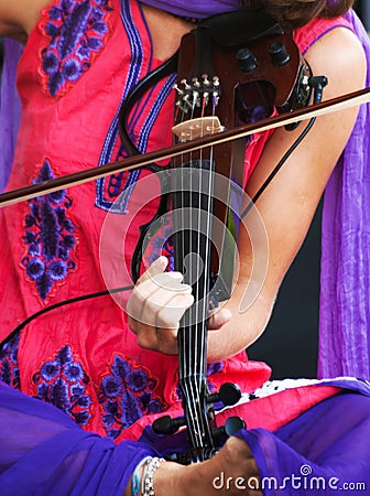 Hands of a musician playing the electric violin