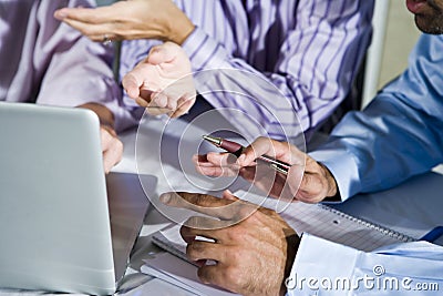 Hands of office workers working on laptop