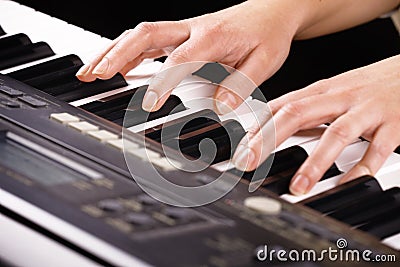 Hands playing music on the piano