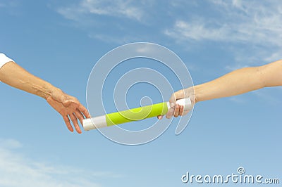 Hands reaching baton for teamwork