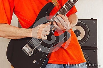 Hands of the rock musician playing the electric guitar